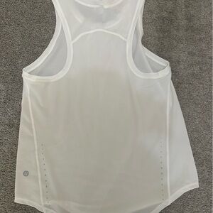 Brand new never worn, tags removed. 
White size 4 Lululemon work out tank top